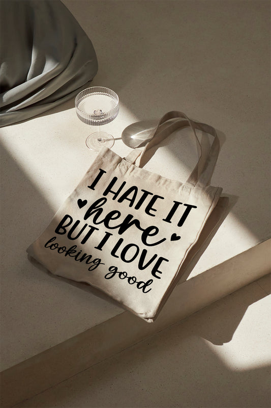 I hate it here but I love looking good Baumwolltasche Stoffbeutel Spruch Bag Fashion Shopping Tasche nachhaltig Schultertasche Geschenk Damen