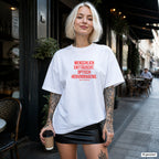 MENSCHLICH ENTTÄUSCHT. OPTISCH HERVORRAGEND. – weißes Oversize T-Shirt mit rotem Frontprint, Damen im Straßencafé