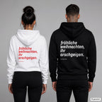 Fröhliche Weihnachten, ihr Arschgeigen – Hoodie mit Backprint, Frau in Weiß mit rotem und Mann in Schwarz mit weißem Aufdruck