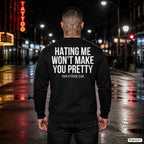 Hating me won’t make you pretty – schwarzer Pullover mit weißem Backprint, Herren in der Stadt bei Nacht