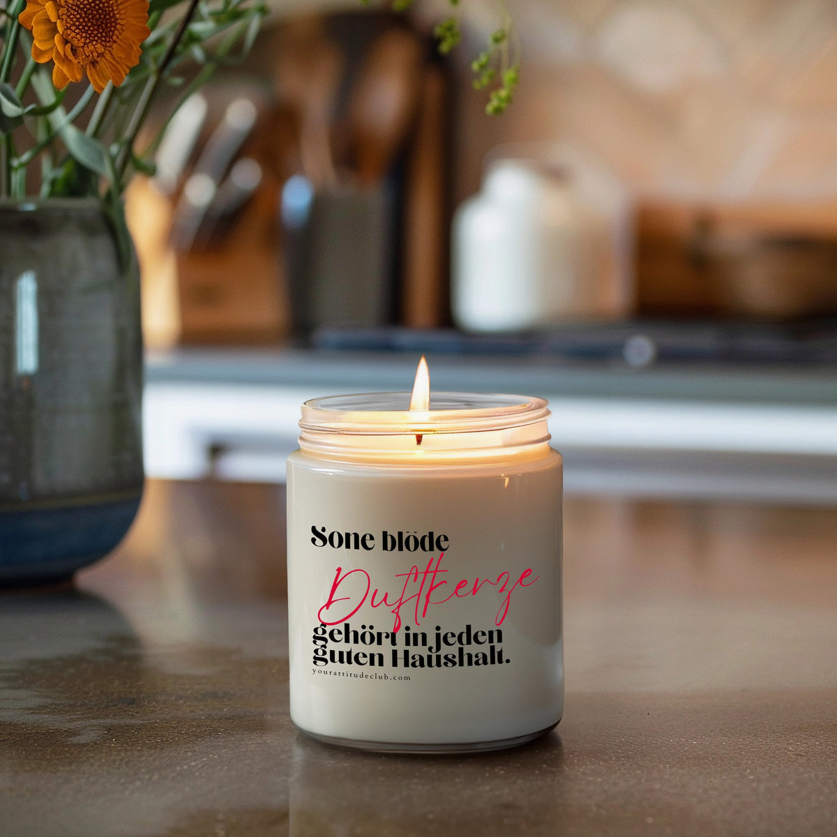 Duftkerze im transparenten Glas mit Spruch „Sone blöde Duftkerze gehört in jeden guten Haushalt.“ – handgemachte Sojawachs-Kerze von Your Attitude Club, brennend in der Küche