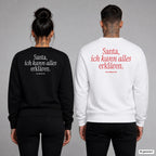 Santa, ich kann alles erklären – Weihnachtspullover mit Backprint, Frau in Schwarz und Mann in Weiß