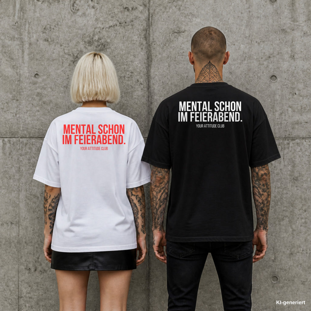MENTAL SCHON IM FEIERABEND. – Oversize Shirt mit Spruch auf dem Rücken, Paar in Weiß und Schwarz vor Betonwand